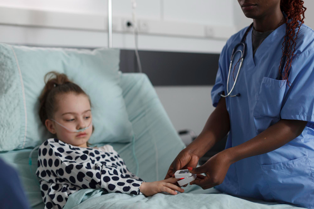 A nurse assisting a young girl in a hospital bed, providing care and support during her stay.